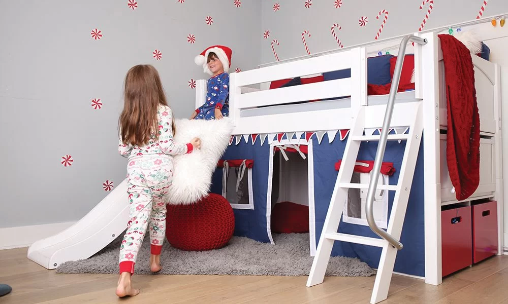two kids playing on loft bed in Christmas