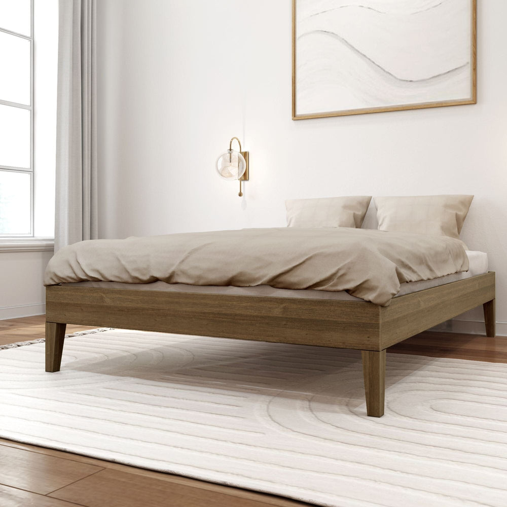 Full Size Platform Bed in Walnut - angled view of the low wooden bed frame with beige bedding in a styled bedroom.