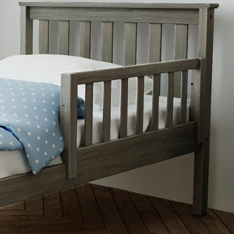 Max and Lily Add on Safety Guard Rail in Clay - the slatted safety rail attached to the side of a bed with a mattress and blue polka dot bedding.
