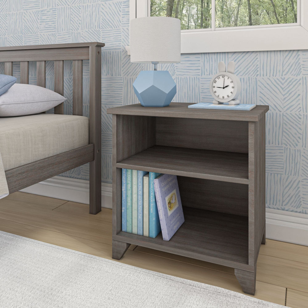 Max and Lily Classic Night Stand With Shelves in Clay - styled in a child's bedroom beside a bed with a lamp, clock, and books on the lower shelf