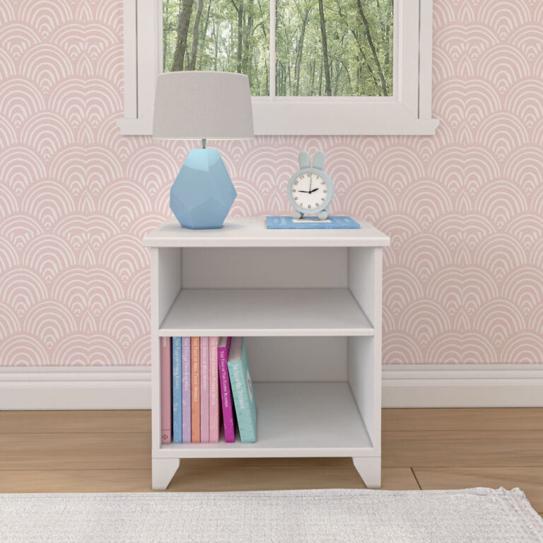 Max And Lily Classic Night Stand With Shelves White Front View Max and Lily Classic Night Stand With Shelves in White - front view against pink wallpaper with a lamp and books on the shelves.