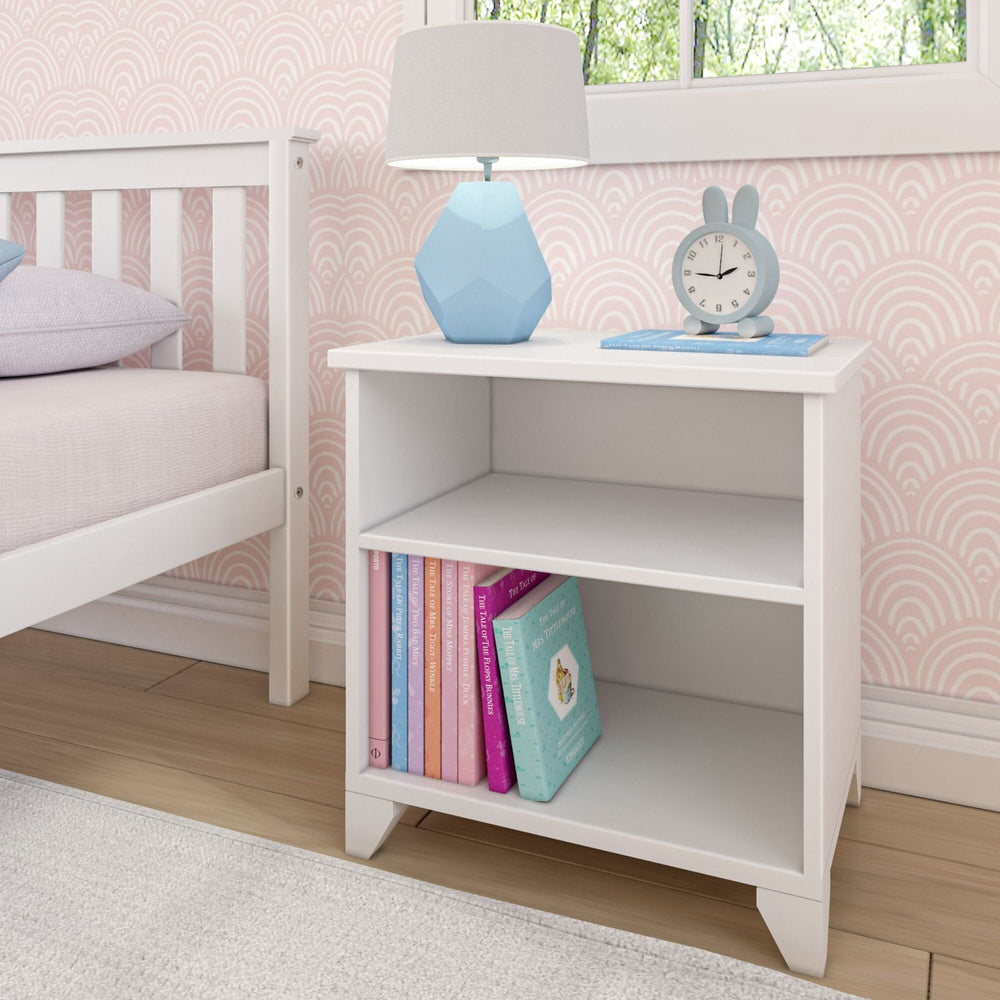 Max and Lily Classic Night Stand With Shelves in White - styled beside a bed with a lamp, clock, and children's books on the open shelves.