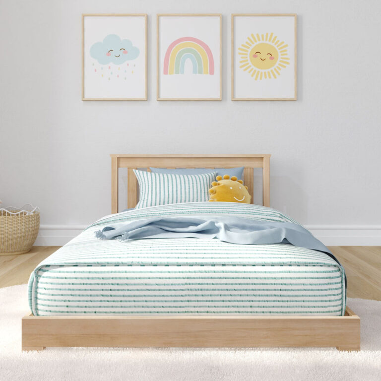 Max and Lily Classic Twin Floor Bed in Blonde - styled in a nursery with striped bedding and framed cloud, rainbow, and sun prints on the wall