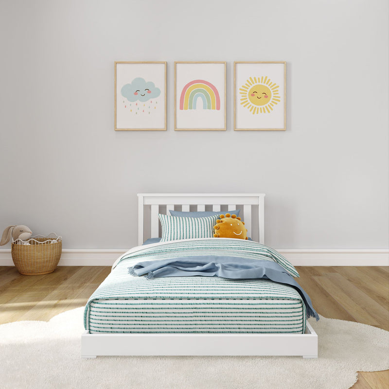 Max and Lily Classic Twin Floor Bed in White - front view in a child's room with slatted headboard and framed rainbow wall prints
