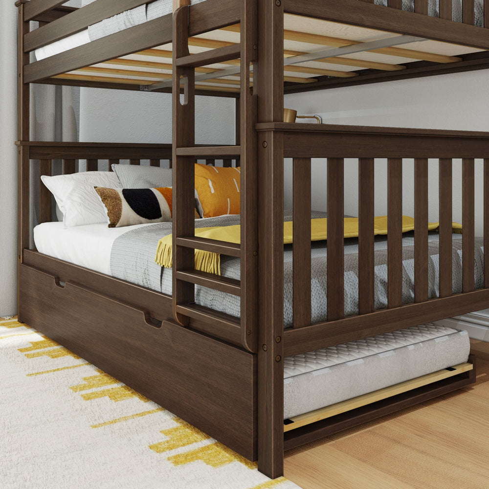 Max and Lily Full Over Full Bunk Bed with Trundle in Walnut - closeup of the lower bunk corner with the ladder, slatted guardrails, and the trundle mattress rolled out.