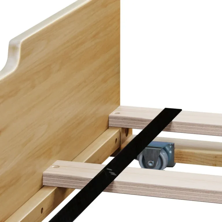 Max And Lily Full Platform Bed With Trundle Natural Caster Wheel Detail 5 Max and Lily Full Platform Bed With Trundle in Natural - close-up of the trundle's caster wheel, plywood slats, and support strap