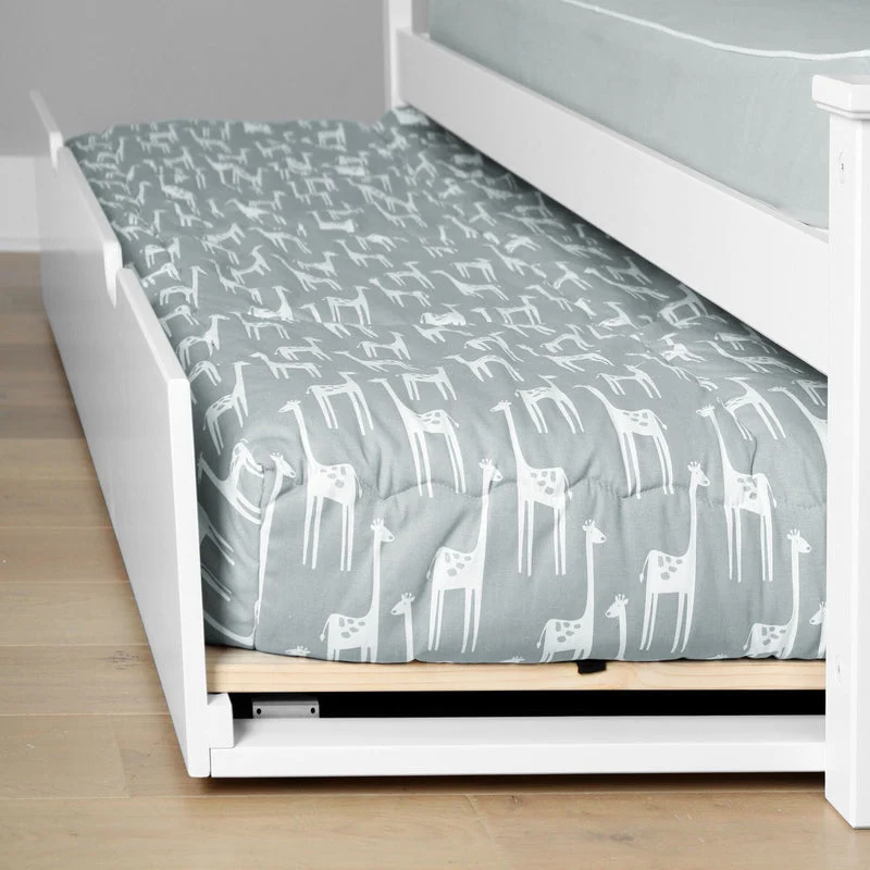 Max and Lily Full Platform Bed With Trundle in White - closeup of the open trundle holding a mattress with grey giraffe-print bedding
