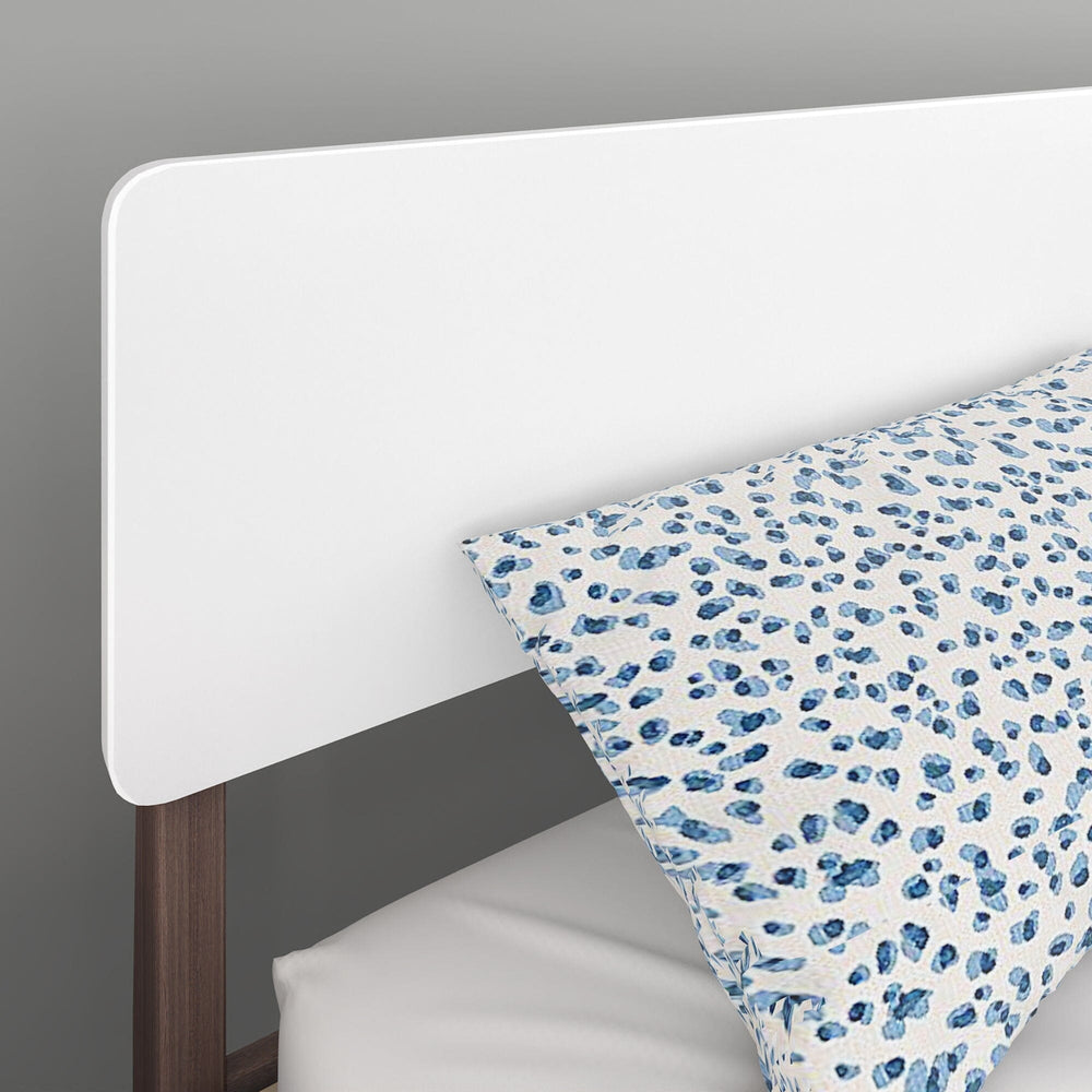 Max and Lily Mid-Century Modern Queen Size Bed in White/Walnut - close-up of the rounded headboard with tapered walnut posts and a patterned pillow