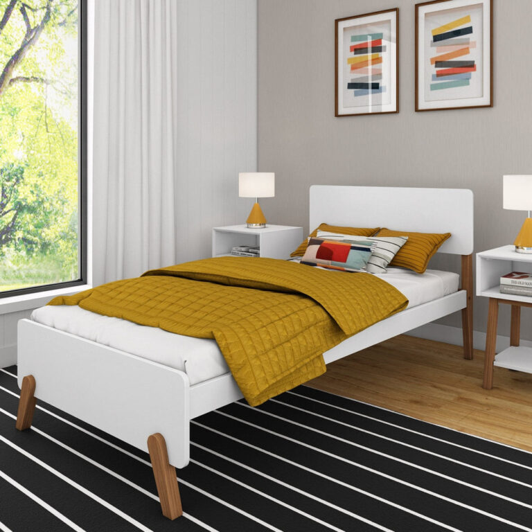 Max and Lily Mid-Century Modern Twin Bed in White/Pecan - angled view in a styled bedroom with mustard bedding, nightstands and angled pecan wood legs on a striped rug