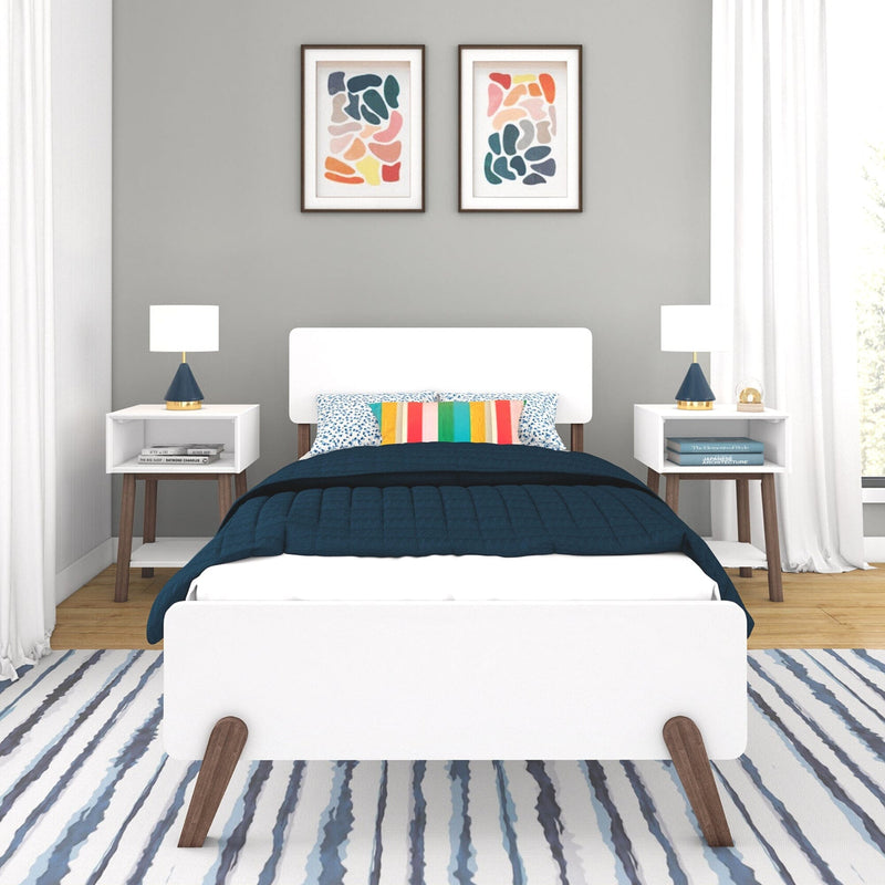 Max and Lily Mid-Century Modern Twin Bed in White/Walnut - front view in a bedroom setting flanked by matching nightstands with lamps and framed wall art