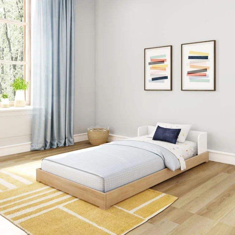 Max And Lily Mid Century Modern Twin Floor Bed White Blonde Angle Room Scene Max and Lily Mid-Century Modern Twin Floor Bed in White/Blonde - angled room scene of the low platform floor bed made up with bedding beside a bright window and yellow rug