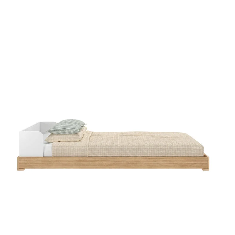Max and Lily Mid-Century Modern Twin Floor Bed in White/Blonde - side view of the low platform frame with mattress, pillows, and rounded headboard end