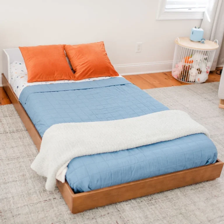 Max And Lily Mid Century Modern Twin Floor Bed White Pecan Foot End View Max and Lily Mid-Century Modern Twin Floor Bed in White/Pecan - view from the foot of the bed showing the low wood frame sitting close to the floor in a kids room