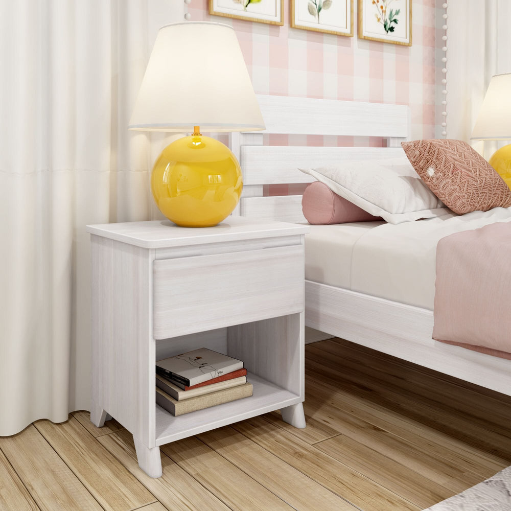 Max And Lily Modern Farmhouse Night Stand White Wash Room Scene 1 Max and Lily Modern Farmhouse Night Stand in White Wash - styled in a kids bedroom beside a bed with a yellow table lamp and books on the open shelf.