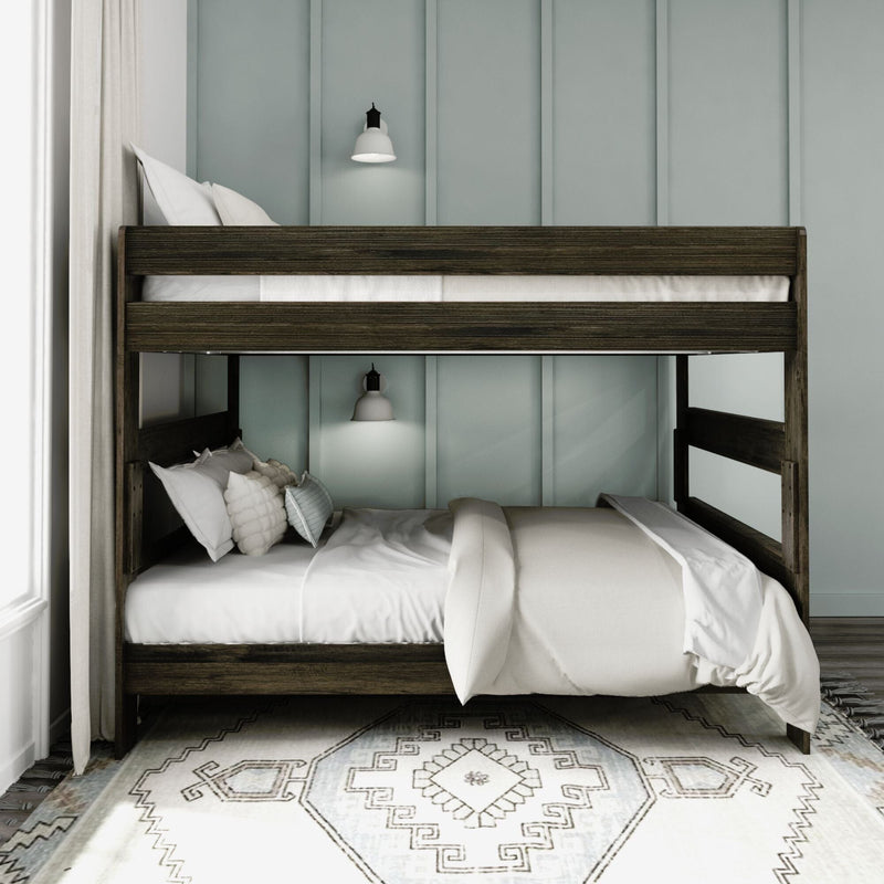 Max and Lily Modern Farmhouse Queen Over Queen Bunk Bed in Barnwood Brown - styled in a bedroom with wall sconces, layered pillows and a patterned area rug