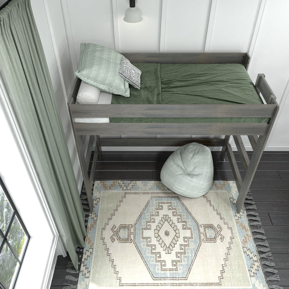 Max and Lily Modern Farmhouse Twin High Loft Bed in Driftwood - overhead view of the made loft bed with green bedding and safety guardrails, with a beanbag chair on the rug below.