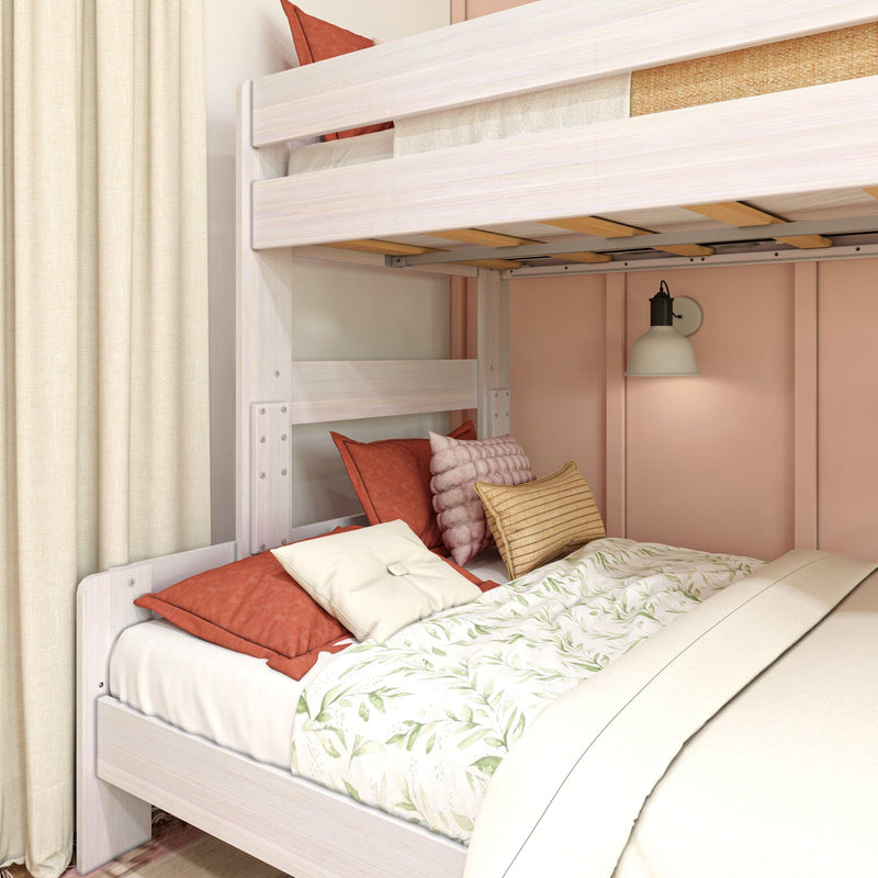 Max and Lily Modern Farmhouse Twin Over Full Bunk Bed - close-up of the full-size lower bunk styled with pillows and bedding beneath the upper bunk's slatted guardrail.