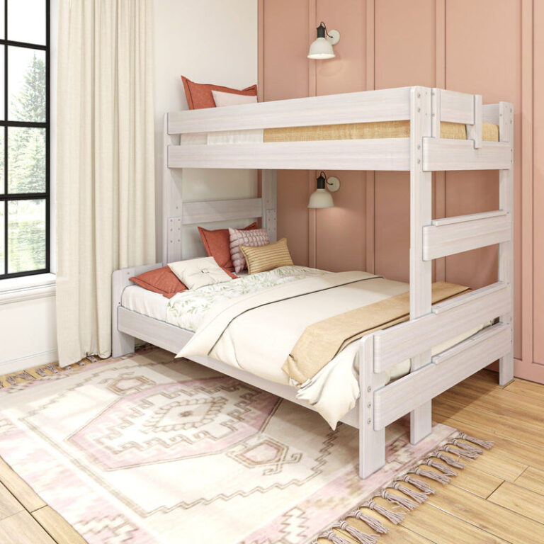 Max and Lily Modern Farmhouse Twin Over Full Bunk Bed - angled view in a styled bedroom showing the full-size lower bunk, upper safety guardrails, and integrated end ladder.