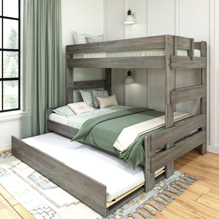 Max and Lily Modern Farmhouse Twin Over Full Bunk Bed With Trundle in Driftwood - styled bedroom with the pull-out trundle extended beneath the full-size lower bunk, green curtains and a window.