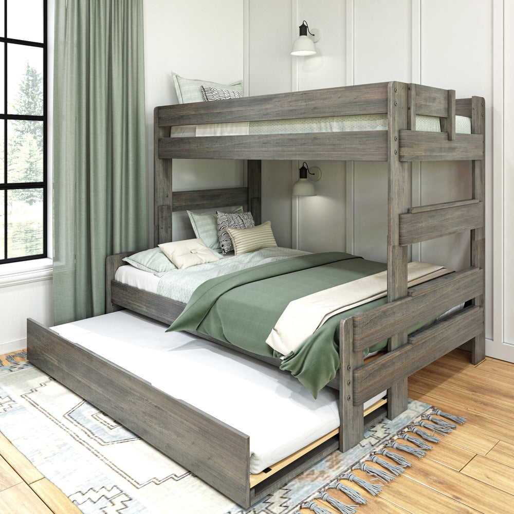 Max and Lily Modern Farmhouse Twin Over Full Bunk Bed With Trundle in Driftwood - styled bedroom with the pull-out trundle extended beneath the full-size lower bunk, green curtains and a window.