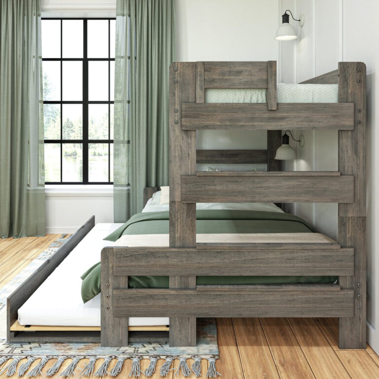 Max and Lily Modern Farmhouse Twin Over Full Bunk Bed With Trundle in Driftwood - angled room view highlighting the ladder and bunk frame with the trundle open beside a curtained window.
