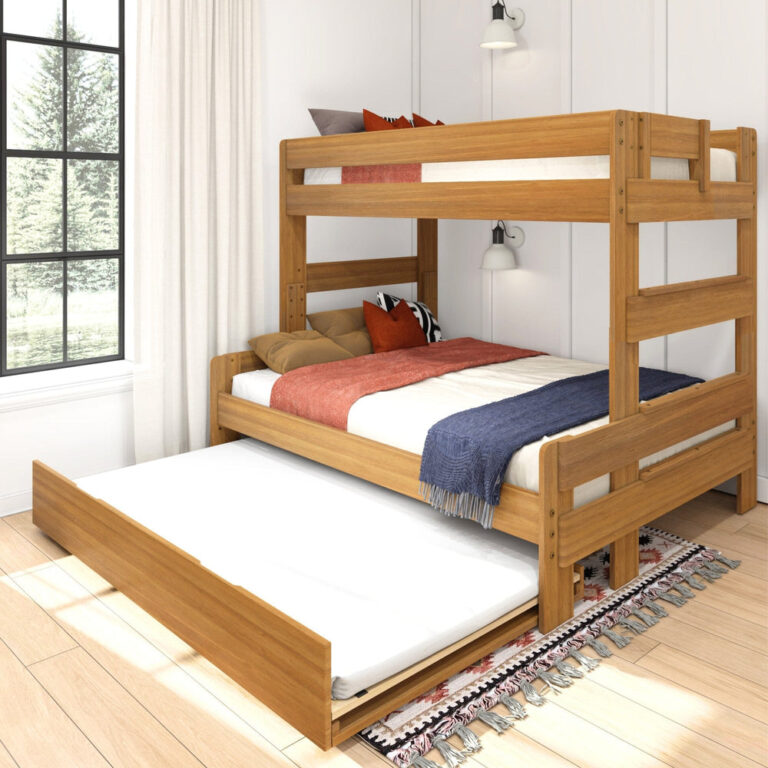 Max and Lily Modern Farmhouse Twin Over Full Bunk Bed With Trundle in Pecan - angled bedroom scene with the pull-out trundle bed extended beside a curtained window and a patterned rug.