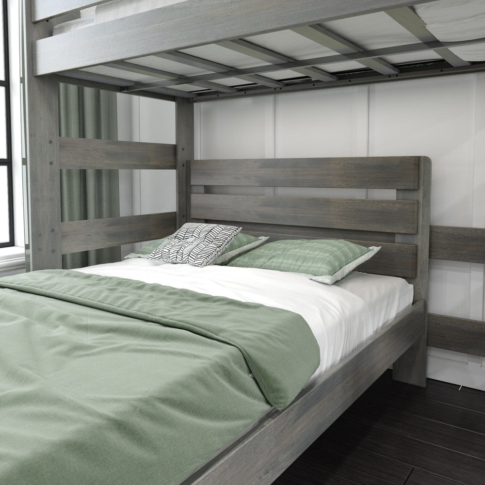 Max and Lily Modern Farmhouse Twin Over Full L-Shaped Bunk Bed in Driftwood - close-up of the lower full bed with headboard and green bedding beneath the upper bunk.