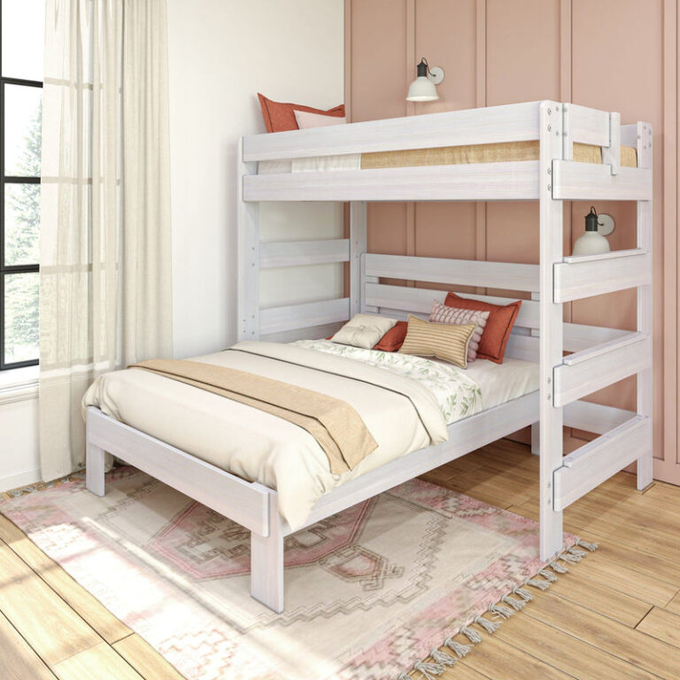 Max and Lily Modern Farmhouse Twin Over Full L-Shaped Bunk Bed in White Wash - angled view in a styled pink bedroom showing the twin bunk over full bed with safety guardrails and end ladder.