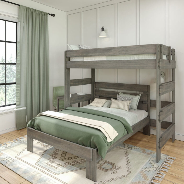 Max and Lily Modern Farmhouse Twin Over Full L-Shaped Bunk Bed With Desk in Driftwood - styled bedroom scene with green curtains and area rug showing the upper loft, lower full bed, and attached desk.