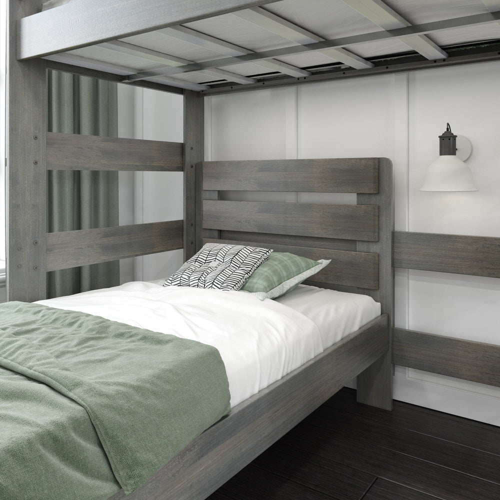 Max and Lily Modern Farmhouse Twin Over Twin L-Shaped Bunk Bed in Driftwood - close-up of the lower bed headboard and mattress with the upper bunk slats above and a wall sconce