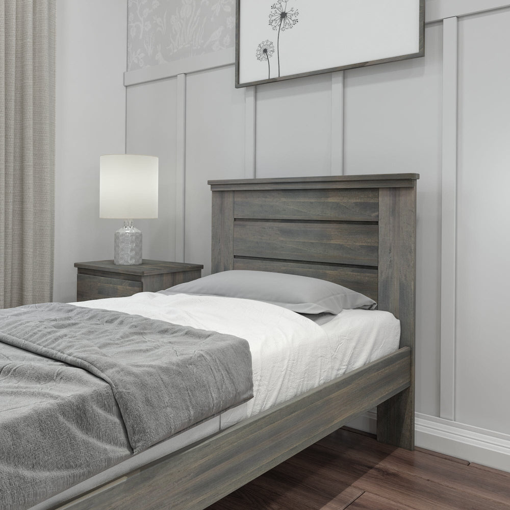 Max and Lily Modern Farmhouse Twin Panel Bed in Driftwood - close-up of the plank-style panel headboard beside a nightstand and lamp