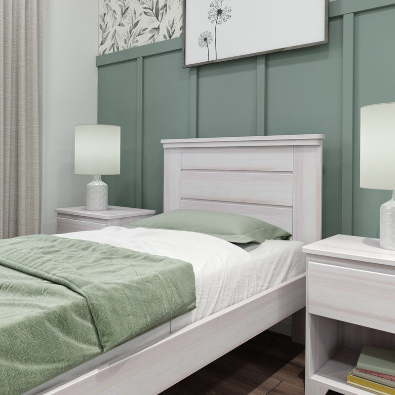 Max and Lily Modern Farmhouse Twin Panel Bed in White Wash - close-up of the paneled headboard against a green wall.