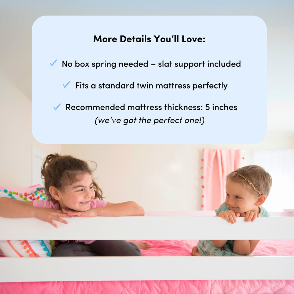 Max and Lily Solid Wood Play and Store Low Loft in Driftwood - two children resting on the mattress behind the guardrail with a note that no box spring is needed.