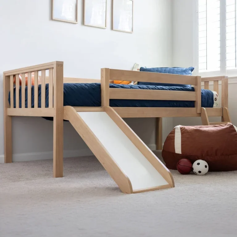 Max And Lily Soren Twin Ultra Low Loft Bed With Slide Blonde Room Scene 1 Max and Lily Soren Twin Ultra Low Loft Bed With Slide in Blonde - angled view in a kids' bedroom showing the attached wooden slide, safety guardrail and navy sports-themed bedding
