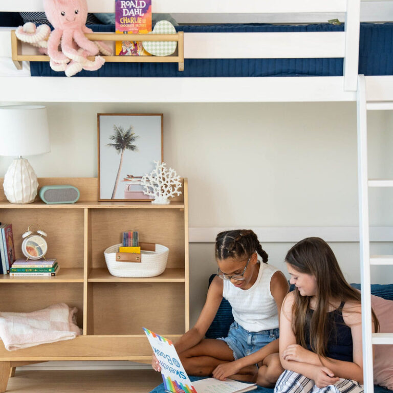 Max And Lily Twin High Loft Bed White Kids Reading Max and Lily Twin High Loft Bed in White - two girls reading beneath the raised loft bed beside a wooden bookshelf.