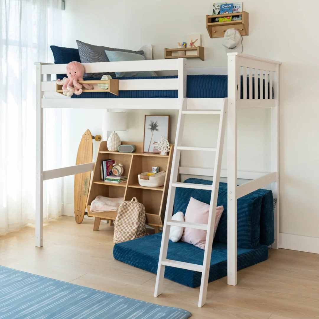 Max and Lily Twin High Loft Bed in White - styled kids' room scene with safety guardrails, angled ladder, and a cozy reading nook with bookshelf and floor cushions under the bed