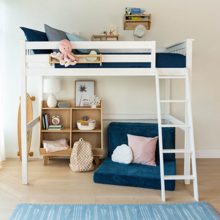 Max And Lily Twin High Loft Bed White Room Scene 2 Max and Lily Twin High Loft Bed in White - loft bed in a kids' bedroom with a ladder, bookshelf, and blue floor cushion seating under the raised bed.