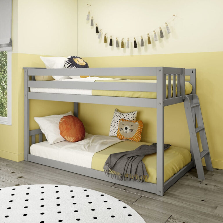 Max And Lily Twin Low Bunk Bed With Ladder On End Grey Room Scene 1 Max And Lily Twin Low Bunk Bed with Ladder on End in Grey - angled view of the low bunk styled in a kids' bedroom with slatted guardrails and a ladder on the end.