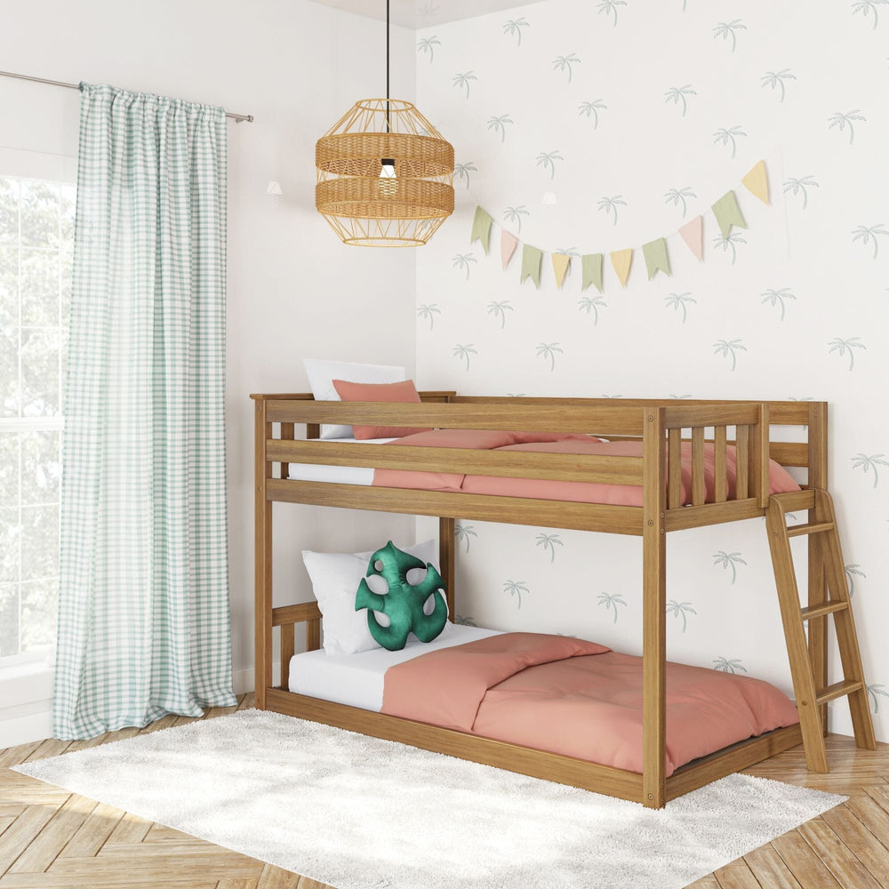 Max And Lily Twin Low Bunk Bed With Ladder On End Pecan Room Scene 1 Max And Lily Twin Low Bunk Bed with Ladder on End in Pecan - angled view styled in a kids room with gingham curtains, a rattan pendant light and coral bedding.