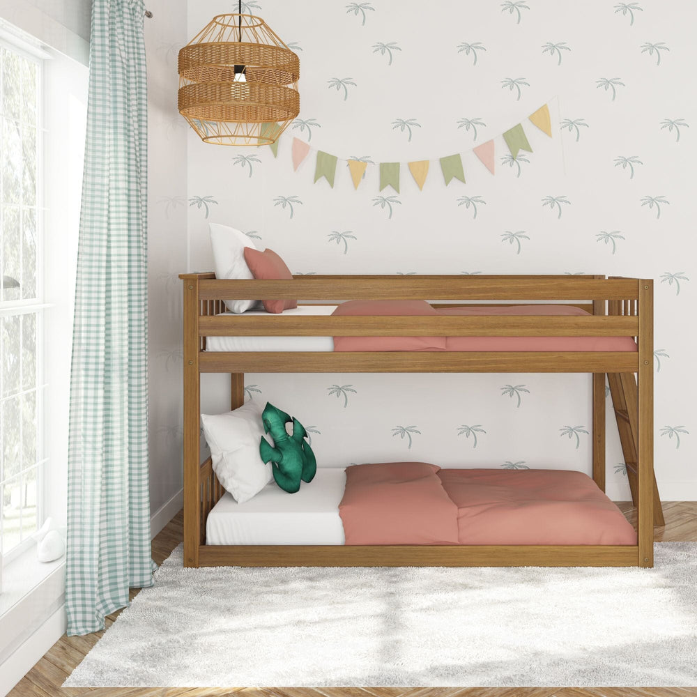 Max And Lily Twin Low Bunk Bed With Ladder On End Pecan Room Scene 2 Max And Lily Twin Low Bunk Bed with Ladder on End in Pecan - front view in a palm-print kids room showing both stacked bunks with guardrails and coral bedding.