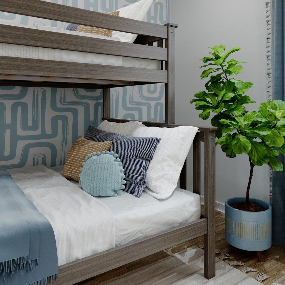 Max and Lily Twin Over Full Bunk Bed With Ladder On End in Clay - close-up of the lower full bed styled with decorative pillows beneath the upper bunk guardrail.
