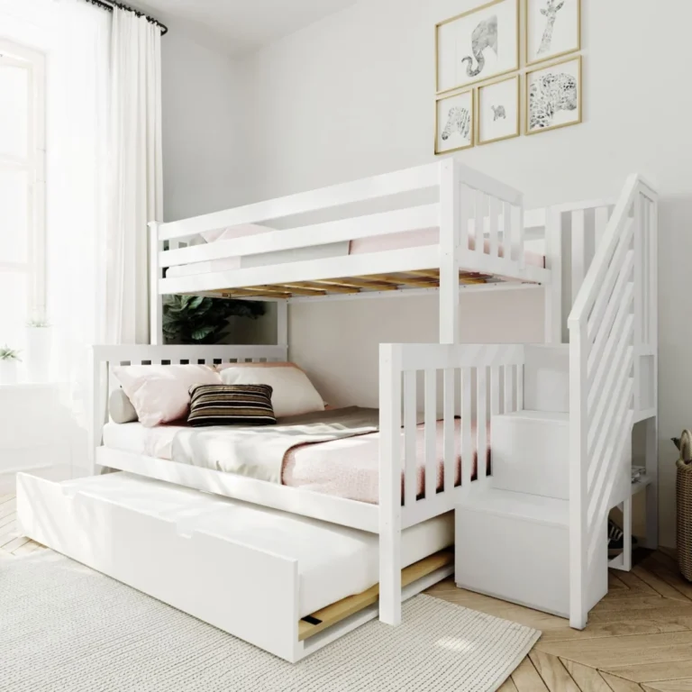 Max and Lily Twin Over Full Bunk Bed with Stairs and Trundle in White - angled view in a bright bedroom with the trundle pulled out, storage staircase on the right and safety guardrails on the top bunk
