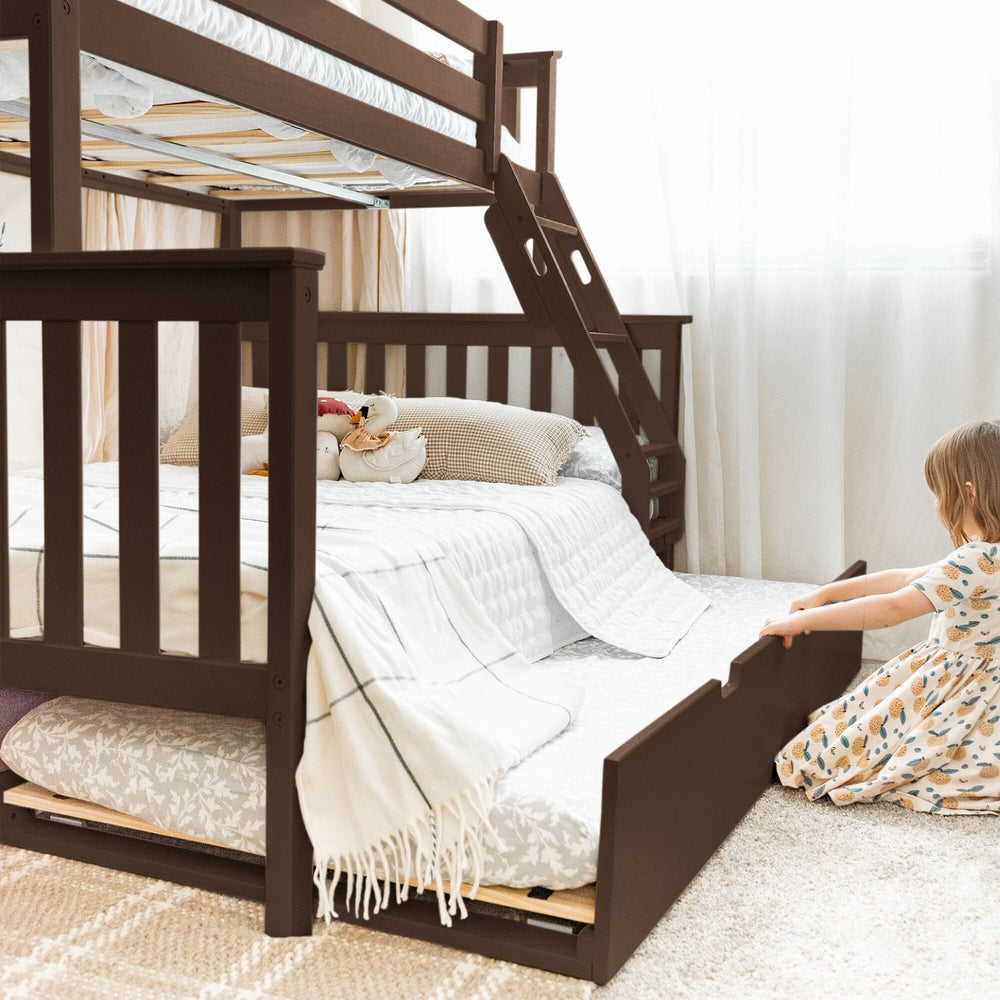 Max and Lily Twin Over Full Bunk Bed with Trundle in Walnut - child pulling out the trundle drawer from under the full-size lower bunk in a bright bedroom