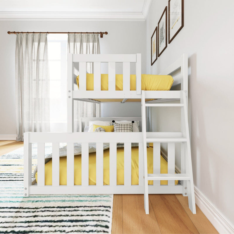 Max and Lily Twin Over Full Low Bunk Bed in White - angled view in a styled bedroom with curtains and framed wall art, showing the offset upper twin bunk, lower full bed, and angled ladder.