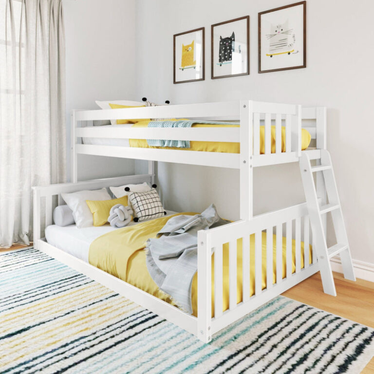 Max and Lily Twin Over Full Low Bunk Bed in White - staged in a kids bedroom at an angle showing the staggered bunks, angled side ladder, guardrails, and yellow bedding on a striped rug.