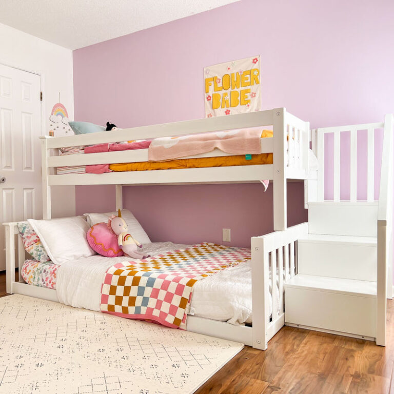 Max And Lily Twin Over Full Low Bunk Bed With Stairs White Room Scene 1 Max and Lily Twin Over Full Low Bunk Bed With Stairs in White - angled view styled in a girl's bedroom with the built-in staircase and made-up lower full bed