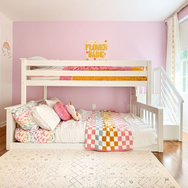 Max And Lily Twin Over Full Low Bunk Bed With Stairs White Room Scene 2 Max and Lily Twin Over Full Low Bunk Bed With Stairs in White - front view made up with colourful bedding beside the staircase in a pink bedroom