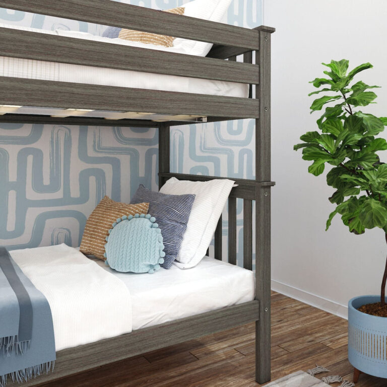 Max and Lily Twin Over Twin Bunk Bed with Ladder on End in Clay - close-up of the end post and upper bunk guardrail above the lower bunk styled with decorative pillows.