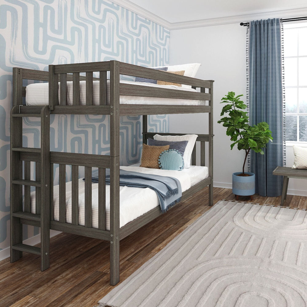 Max and Lily Twin Over Twin Bunk Bed with Ladder on End in Clay - angled view in a styled bedroom with blue patterned wallpaper, the ladder mounted on the end, full-height guardrails, and made-up bunks.