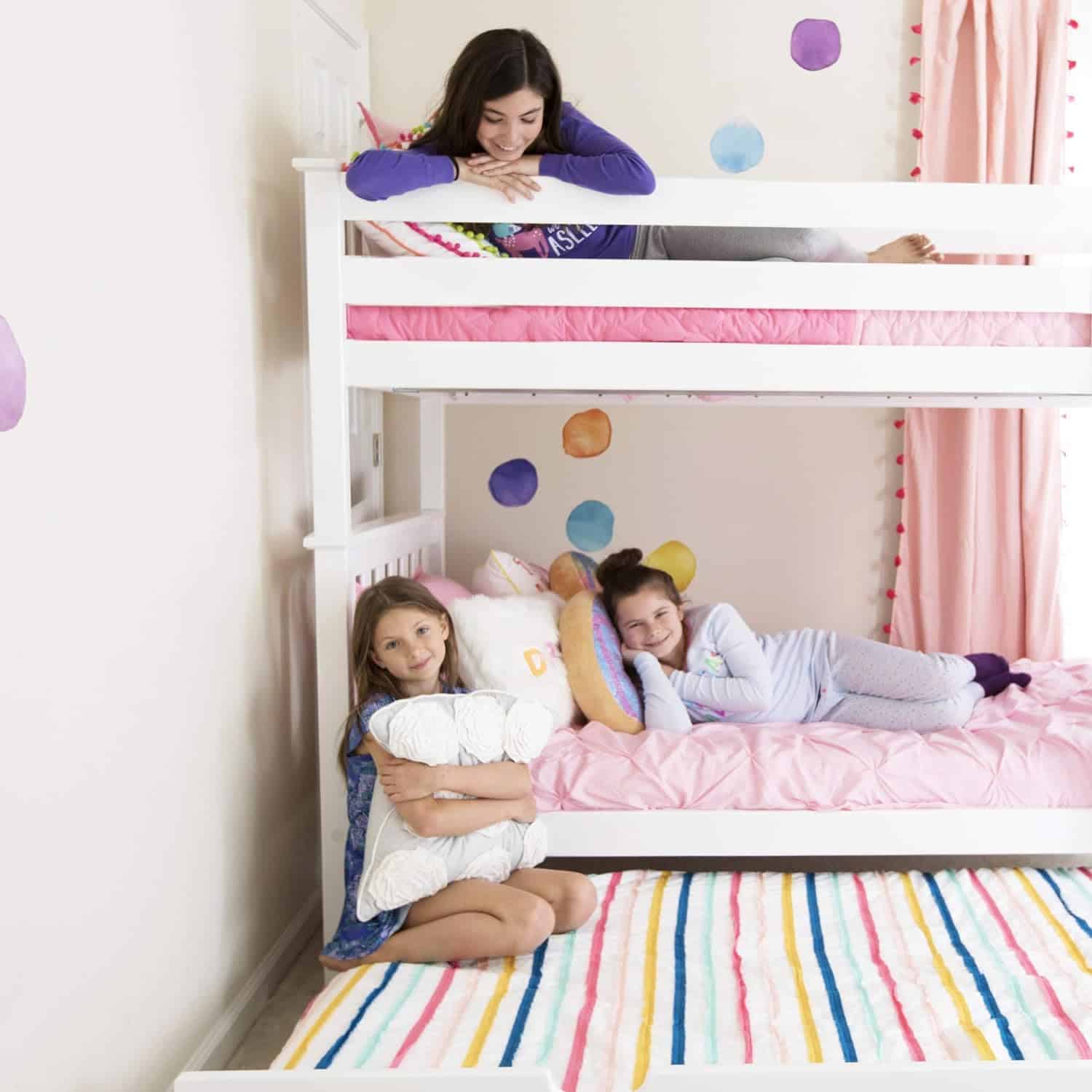 Max and Lily Twin Over Twin Bunk Bed with Stairs and Trundle - three girls playing on the bunk with the trundle bed rolled out beneath